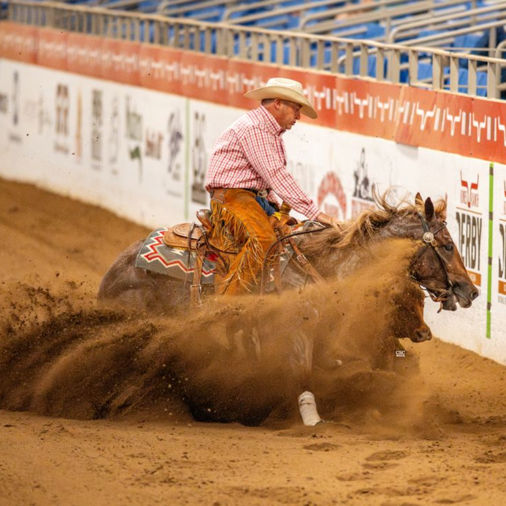 Cowboy on horseback competing in a rodeo event with a bull in a dirt arena.